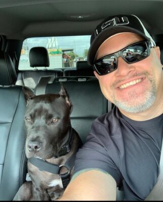 man clicking selfie with pitbull